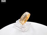an image of a gold wedding ring on a clear stand
