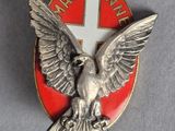 an image of a red and white badge with an eagle on it