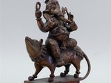 an image of a bronze statue of a man riding on a horse