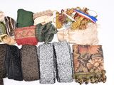 many different types of scarves laid out on a white surface
