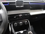 a car dashboard with a phone in the center of it