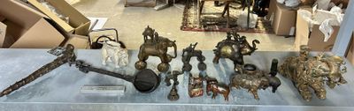 a lot of antique items on display in a glass case