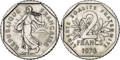 a close up of a coin with a woman on it