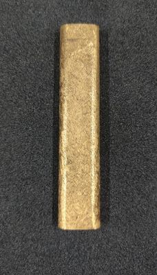 a close up of a metal object on a black surface