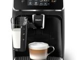 a black coffee machine with a glass of milk in front of it