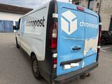 a blue and white van parked in a parking lot