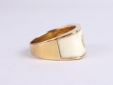 an image of a white and gold ring on a white surface