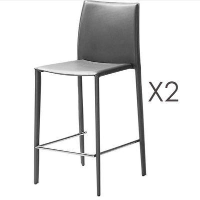 a pair of black leather bar stools next to each other