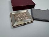 a small silver box and a small red box