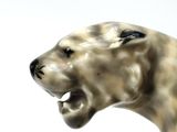 a statue of a lion with its mouth open
