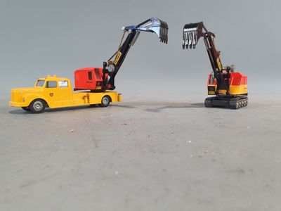 two toy trucks that are sitting next to each other