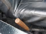 a baseball bat sticking out of the back of a car seat