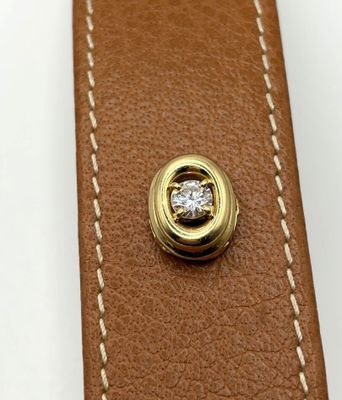 an image of a close up of a leather belt with a diamond in the center