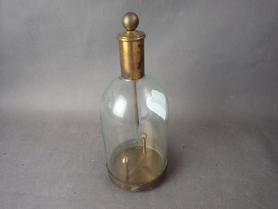 une petite bouteille en verre avec un bouchon doré posée sur une table