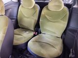 two seats in the back of a car that are green