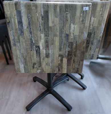 a small table with a wooden top on a wooden floor