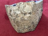 a rock that is sitting on a red surface