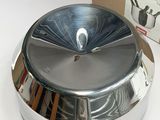 a silver plate with a teapot on it next to a brown paper bag