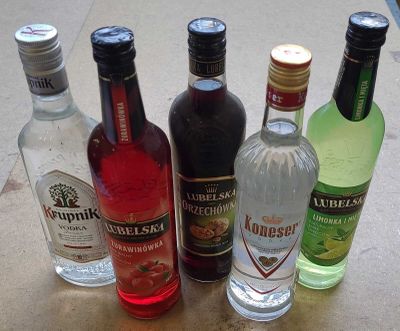 bottles of different types of alcohol lined up on a table
