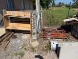 a pile of junk in the yard next to a fence