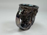 a silver cup with a lion on it on a table