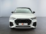 the front view of a white audi vehicle parked in a showroom