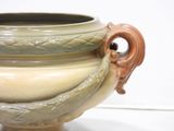 a large vase that has a handle on it