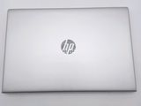 the hp laptop is sitting on a white surface with a logo on it