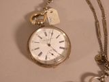 a silver pocket watch with a chain attached to it