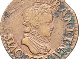 gros plan d'une pièce de monnaie sur laquelle figure une tête d'homme