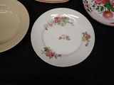 three plates on the table with flowers on them
