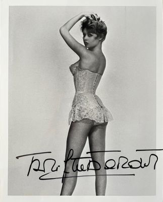 black and white photograph of a woman in a corset posing for a picture