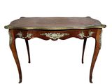 a small table with a wooden top and gold trimmings