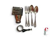 a spoon, fork, and knife next to a piece of chocolate