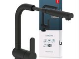 a close up of a black faucet with a box in the background