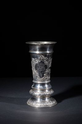 an antique silver cup on a black background with a black background