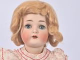 a doll with blonde hair and blue eyes on a white background