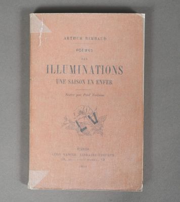an old book sitting on top of a table on a gray surface