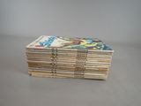 a lot of comics stacked on top of each other