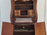 a wooden cabinet with a door open on a white floor