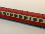 a red and white train car on a white surface
