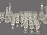 a lot of glasses and a pitcher on the table