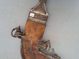 an old wooden knife holder with a metal handle