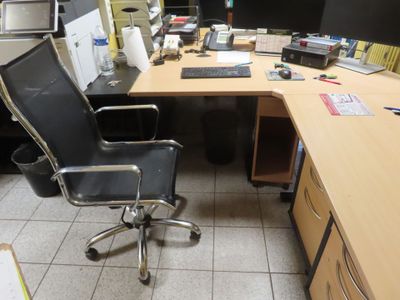 a desk with a chair and a computer on it