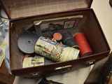 a brown suitcase with a bunch of items inside of it