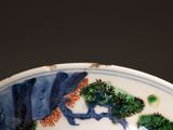 a blue and white plate with a picture of a tree on it