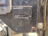 a close up of a parking meter with a car in the background