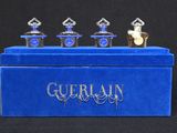 a close up of a blue box with three perfume bottles on it