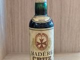 a bottle of liquor sitting on a wooden table