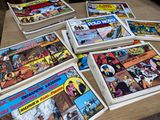 a lot of comics on the table together